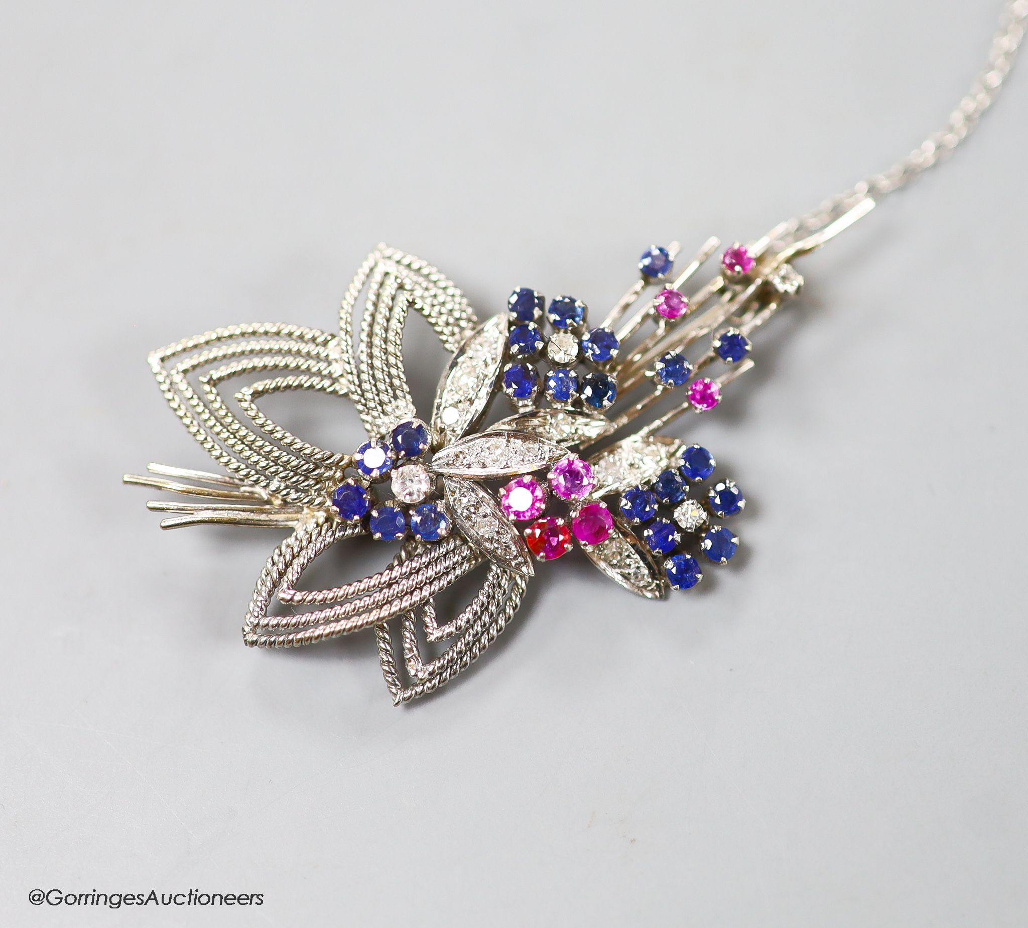 A modern white metal, ruby, sapphire and diamond set foliate spray brooch, 567mm